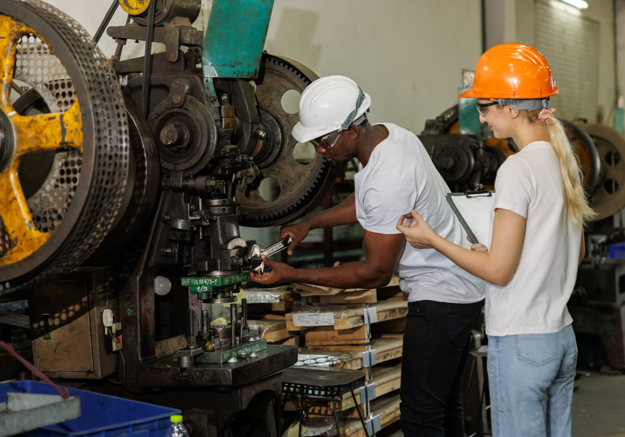 professional engineer team inspecting service machine in heavy industry factory